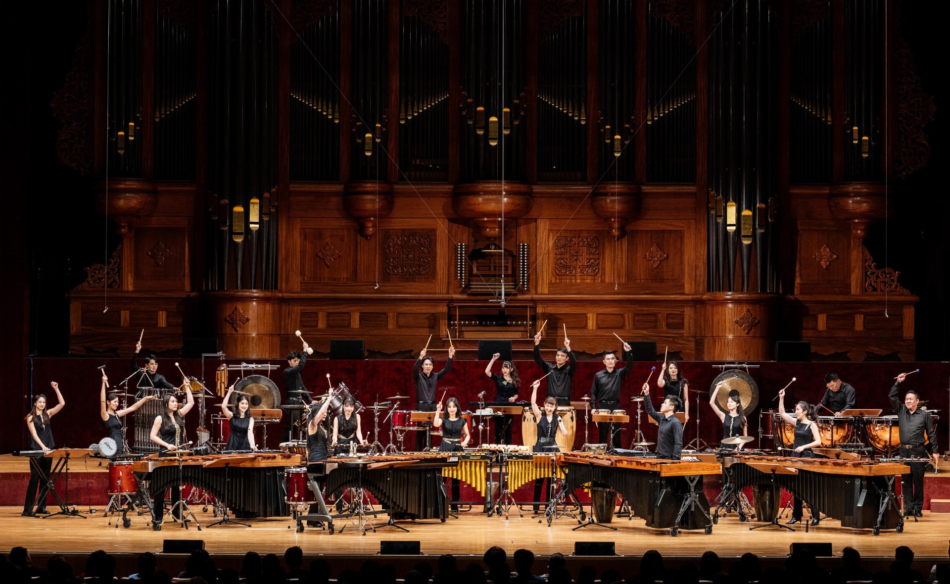Ju Percussion Group performing on stage with pipe organ